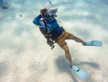 diver doing a relaxed wacky pose underwater