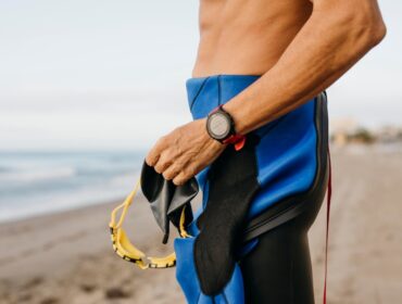 man wearing and holiding Cressi diving gear