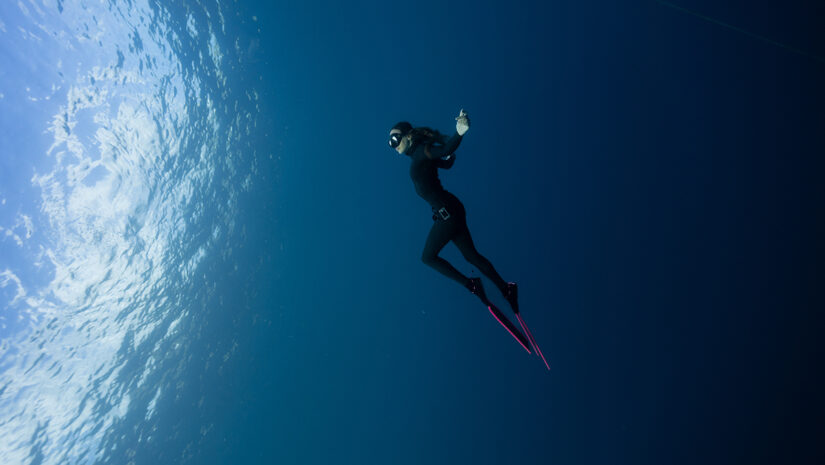 british freediver posing in the ocean