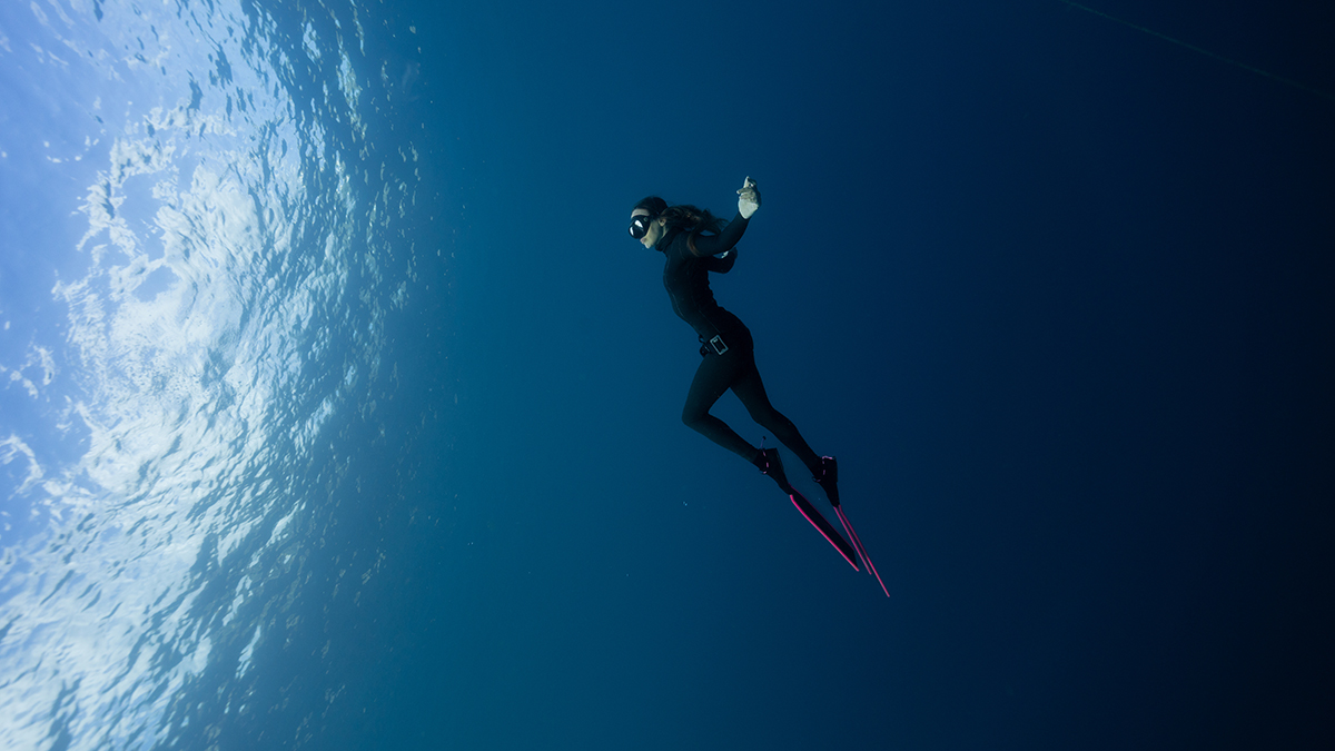 british freediver posing in the ocean
