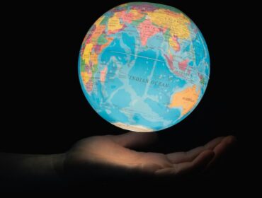 glowing Earth globe floating from hand