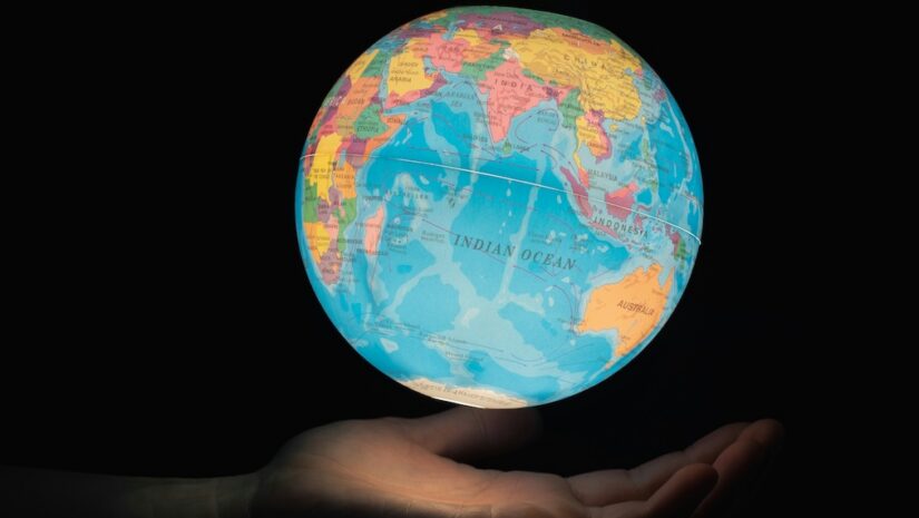 glowing Earth globe floating from hand