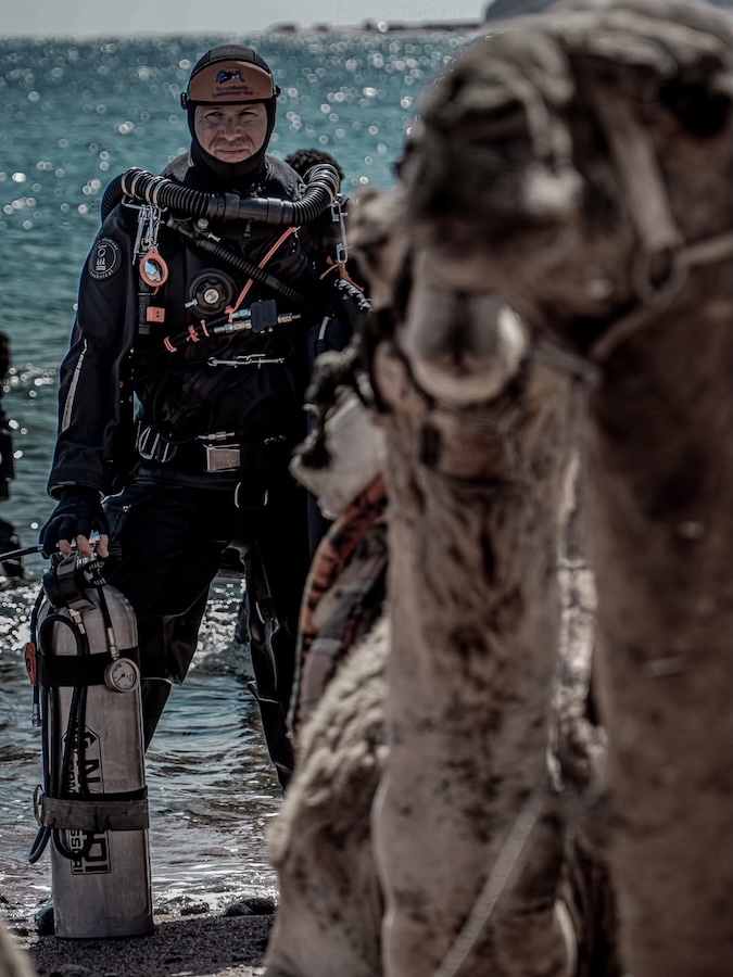 diver gazes into camera wearing full scuba diving gear