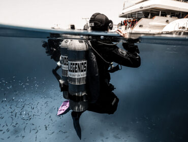 scuba diver treading water looking above the surface